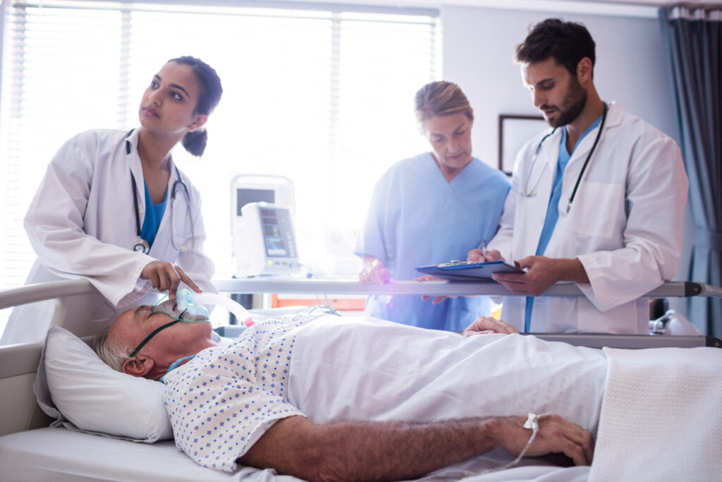 Doctor putting Oxygen mask on patient who came after investigation of endoscopy due to peptic ulcer