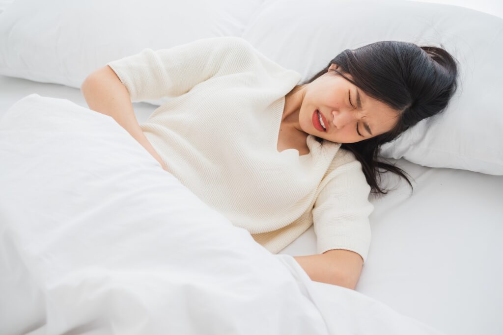 A women feels nausea due to peptic ulcer disease 