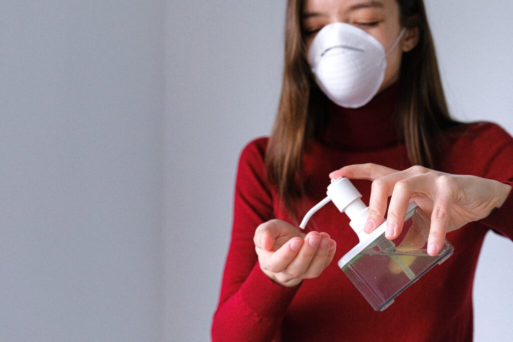 Women wearing a Mask and apply Sanitizer for protection