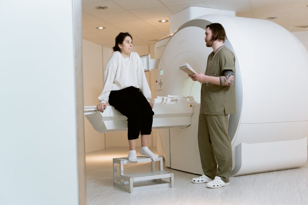 Male radiologist explains about CT scan to his patient